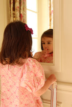 將圖片載入圖庫檢視器 Young girl in a pink dress looking at her reflection in a mirror.