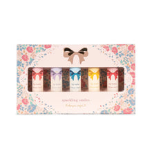 將圖片載入圖庫檢視器 A set of five lip balm glitter products in various colors, packaged in a box with a floral design and a bow.