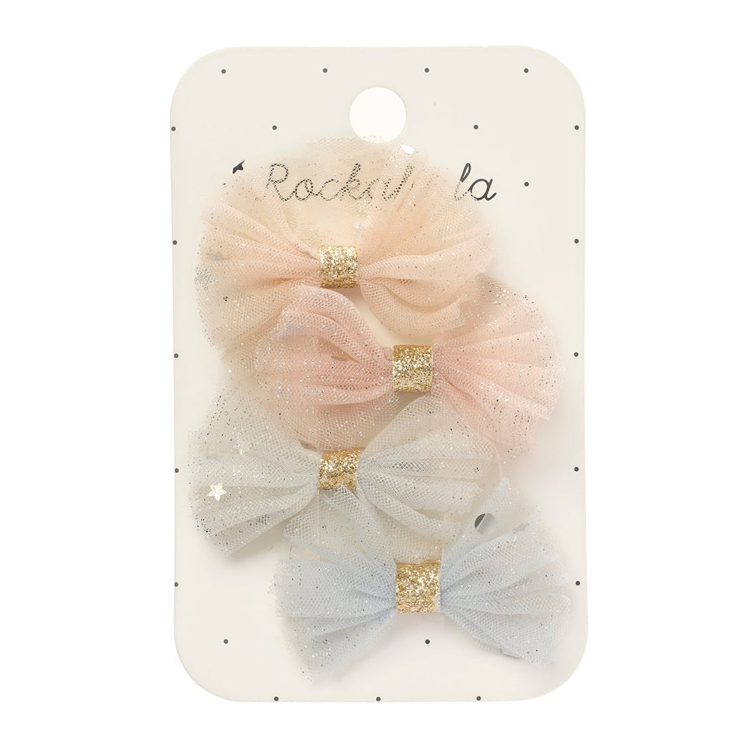 Packaged hair bows with blush and gray colors on a white background