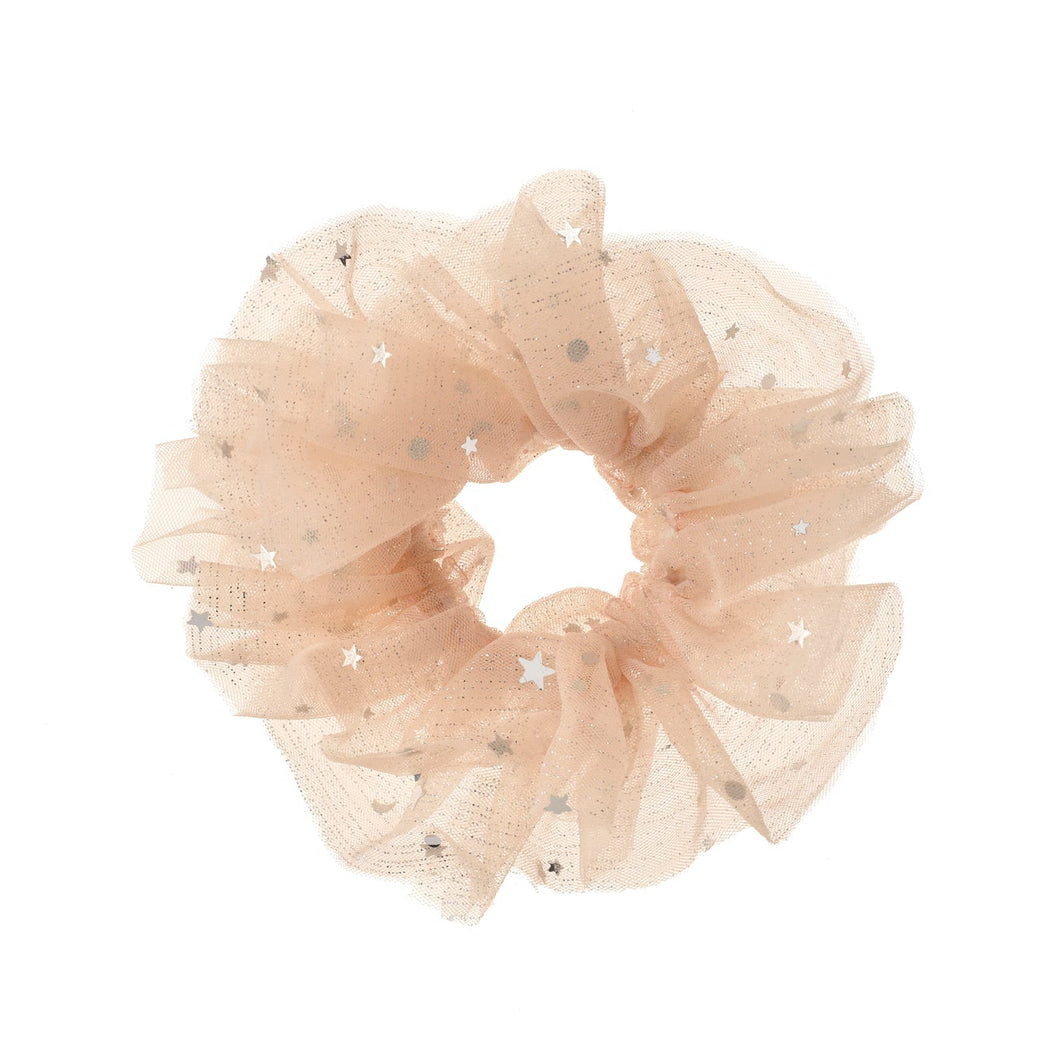 Beige scrunchie with star patterns on a white background