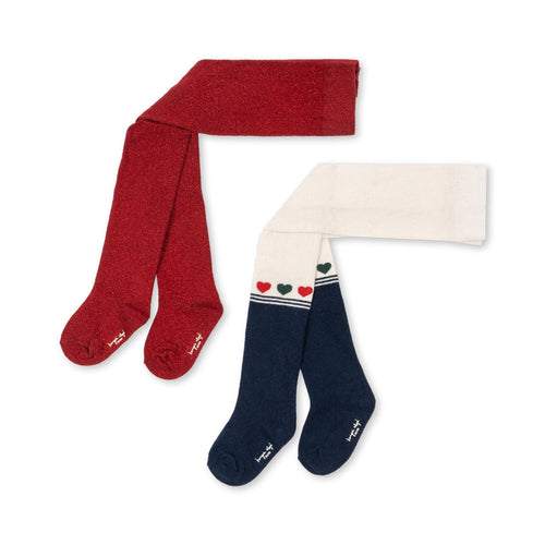Red tights and navy socks with heart designs on a white background