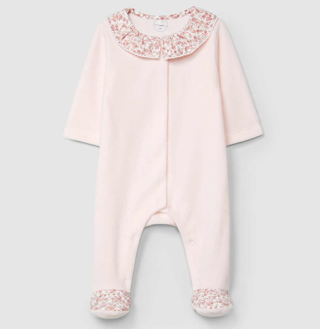Pink baby onesie with floral details on a light gray background