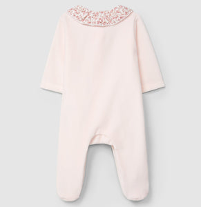 Pink baby onesie with floral embroidery on a light gray background