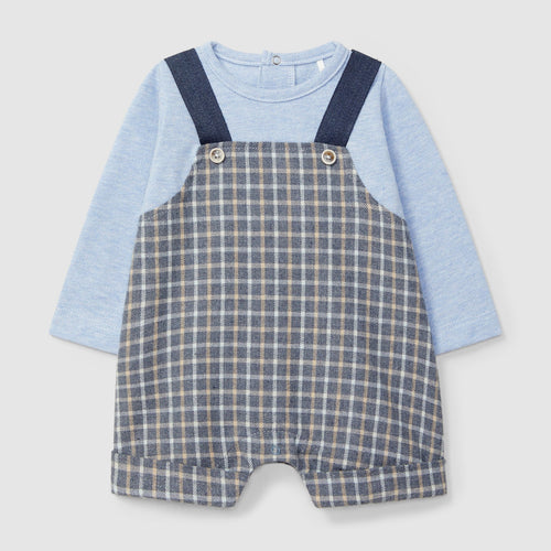 Baby outfit with blue long-sleeve shirt and checkered overalls on a light gray background