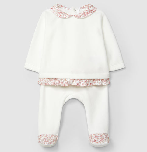 White baby outfit with pink floral details on a light gray background