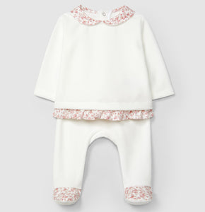 White baby outfit with pink floral details on a light gray background