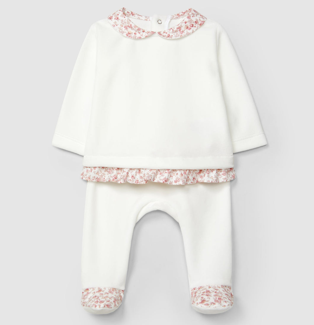White baby outfit with pink floral details on a light gray background