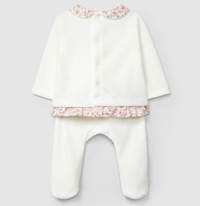 White baby outfit with floral details on a light gray background