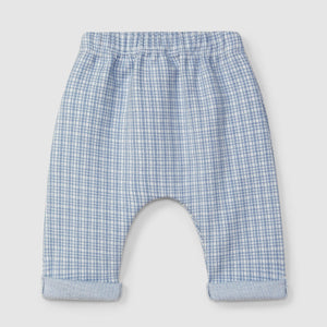 Blue checkered baby pants on a light gray background