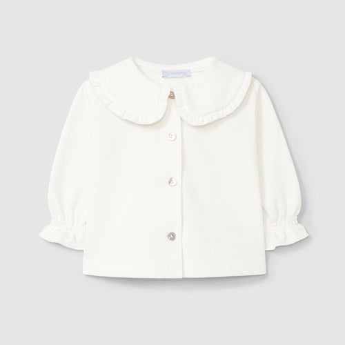 White blouse with a Peter Pan collar on a light gray background