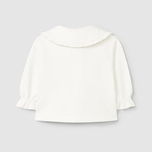 White cropped jacket on a light gray background