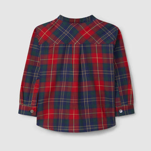 Red and blue plaid shirt on a light gray background