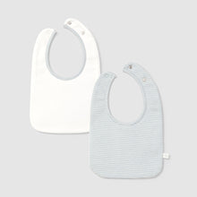 Load image into Gallery viewer, Two baby bibs, one plain white and one with a subtle pattern, on a light gray background.