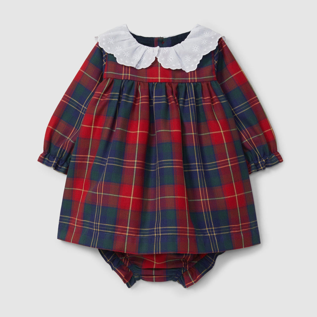 Red and blue plaid baby dress with white collar on a light gray background