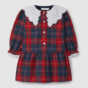 Red and blue plaid dress with lace collar on a light gray background