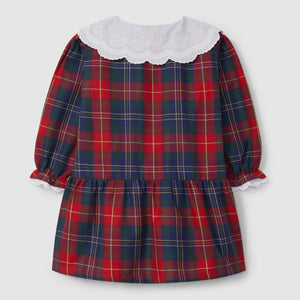 Red and blue plaid dress with white collar on a light gray background