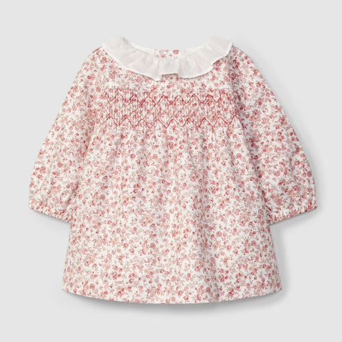 Floral blouse with a white collar on a light gray background