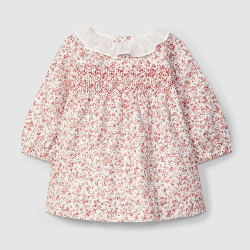 Floral blouse with a white collar on a light gray background