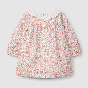 Floral blouse with a white collar on a light gray background