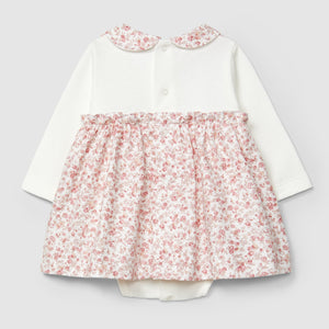 White dress with floral skirt and collar on a light gray background