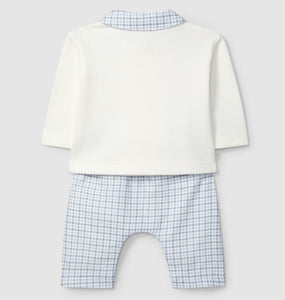 Children's outfit with white shirt and blue checkered shorts on a light gray background