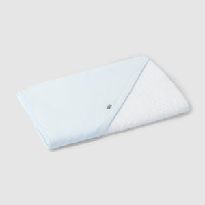 Folded light blue towel on a white background