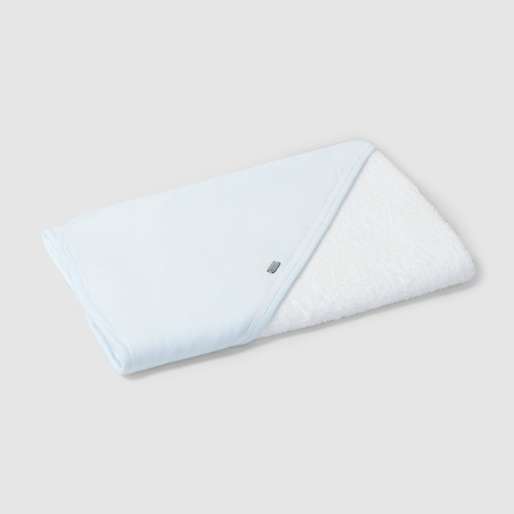 Folded light blue towel on a white background
