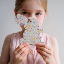 Load image into Gallery viewer, MIMI &amp; LULA Easter stick-on earrings headband with festive, colorful Easter-themed designs on a soft fabric headband.