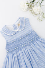 Load image into Gallery viewer, Kidiwi Maud smocked dress in cornflower blue striped fabric, featuring a charming, comfortable design for girls.