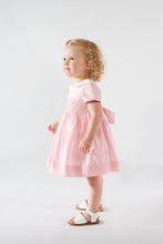 Load image into Gallery viewer, Kidiwi Clémence smocked dress in Fairy Tale pink poplin, featuring ruffled details and a comfortable, stylish fit for young girls.