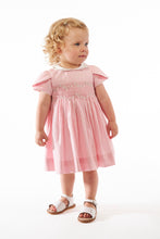 Load image into Gallery viewer, Kidiwi Clémence smocked dress in Fairy Tale pink poplin, showcasing a charming, sleeveless design with delicate smocking details.