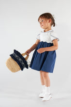 將圖片載入圖庫檢視器 Kidiwi Célestine navy seersucker dress displayed flat, showing the lightweight, textured fabric and classic dress silhouette.