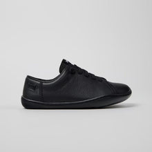 Load image into Gallery viewer, Black sneaker on a light gray background