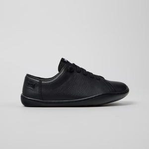 Black sneaker on a light gray background