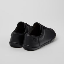 Load image into Gallery viewer, Pair of black slip-on shoes on a light gray background