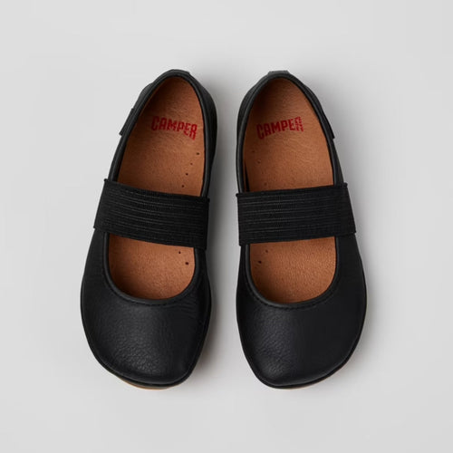 Pair of black shoes with velcro straps on a light gray background