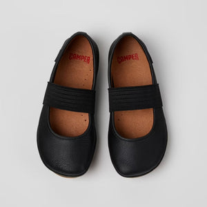 Pair of black shoes with velcro straps on a light gray background