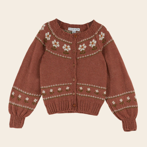 Brown knitted sweater with floral patterns on a beige background