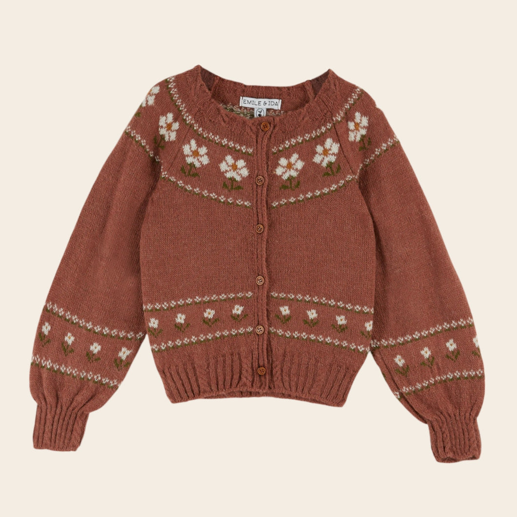 Brown knitted sweater with floral patterns on a beige background