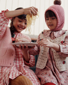 Loose-fitting pink dress with red flowers