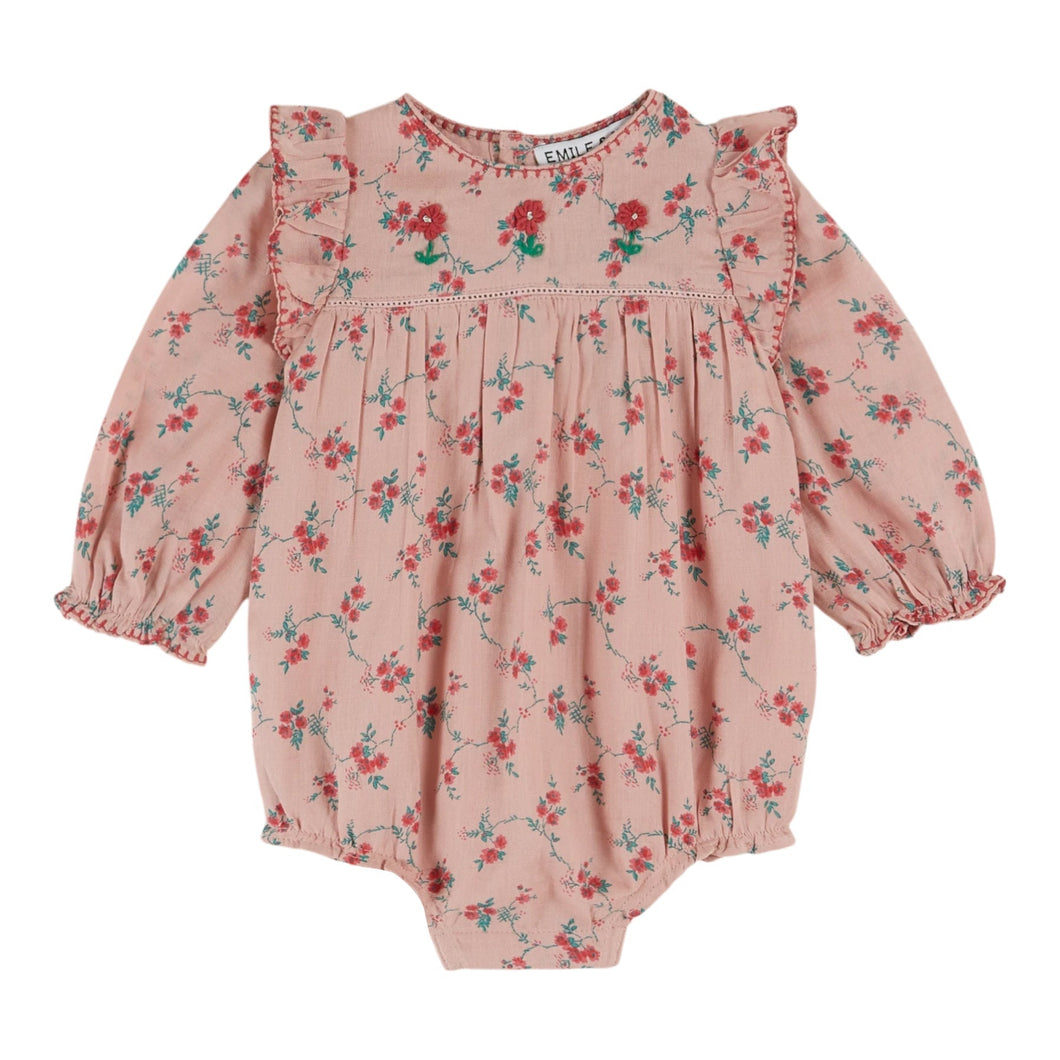 Pink floral baby romper on a white background