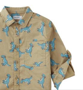 Children's shirt with blue dinosaur pattern on a beige background