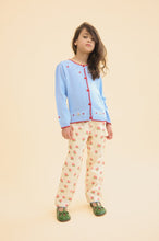 將圖片載入圖庫檢視器 Child wearing a light blue cardigan with red buttons and patterned pants on a beige background