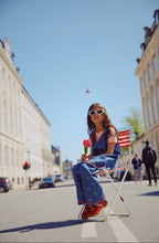 Load image into Gallery viewer, Flöss Eva denim blue dress with bow, showcasing a stylish and comfortable design, perfect for casual or semi-formal wear.