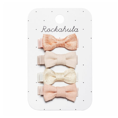Set of four pink and beige bow hair clips on a Rockahula branded card.