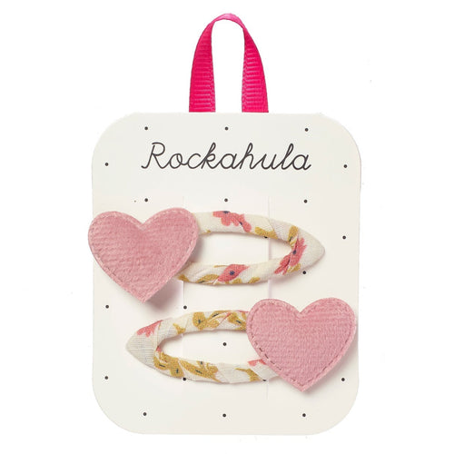 Heart-shaped hair clips with floral designs on a Rockahula branded card.
