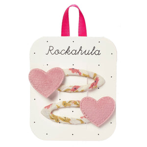 Heart-shaped hair clips with floral designs on a Rockahula branded card.
