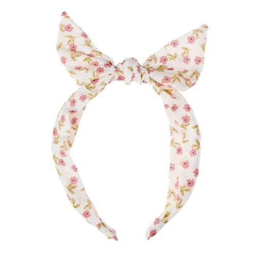 Floral patterned headband with a bow on a white background