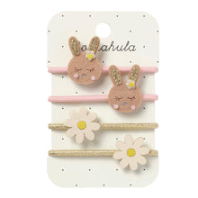 Load image into Gallery viewer, Set of bunny-shaped hair ties with flowers on a branded card against a white background