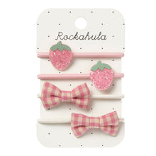 Load image into Gallery viewer, Set of pink strawberry and bow hair clips on a Rockahula branded card.
